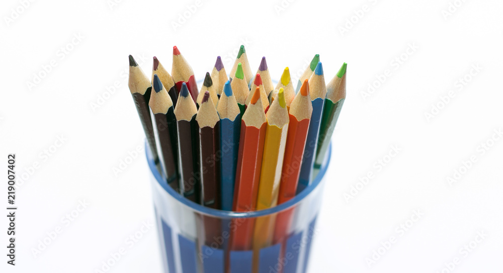 colored pencils in a glass isolated on business background colored pencils in a glass isolated on business background