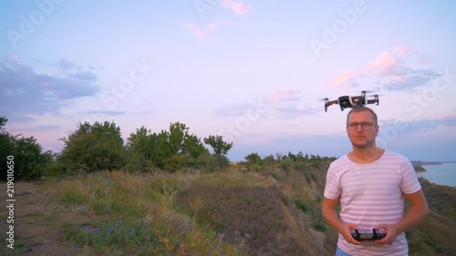 Quadrocopter takes off from the hands of men. The flight of a professional pilot in slow motion. photo