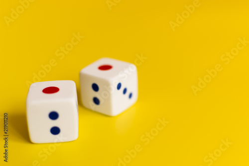 white dice on yellow background