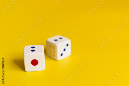 white dice on yellow background