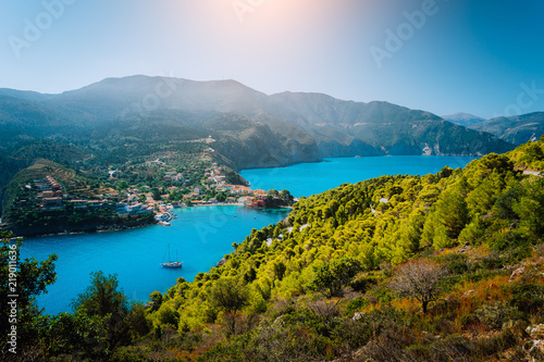 Panoramic view to Assos village Kefalonia. Greece. Beautiful turquoise colored bay lagoon water surrounded by pine and cypress trees along the coastline