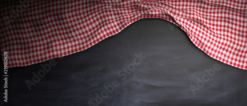 Red white checkered picnic tablecloth on chalkkboard, copy space. 3d illustration