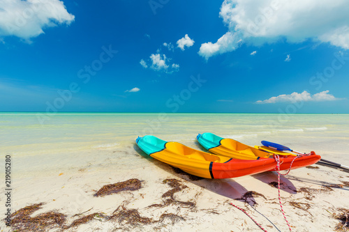 Canoes on pristine sunny tropical beach