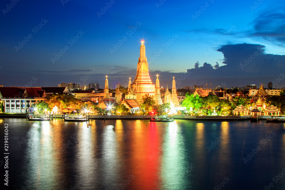 Wat Arun Buddhist Temple at sunset in bangkok Thailand. Wat Arun is among the best known of Thailand's landmarks. Temple Chao Phraya Riverside. The tourist like to take pictures and admire the beauty.