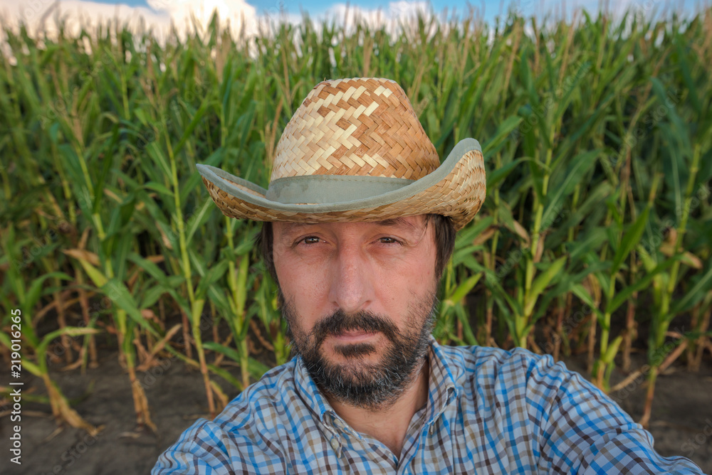 Farmer making selfie portrait in corn field