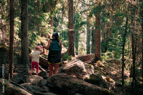 Hiking in the woods. Mother...