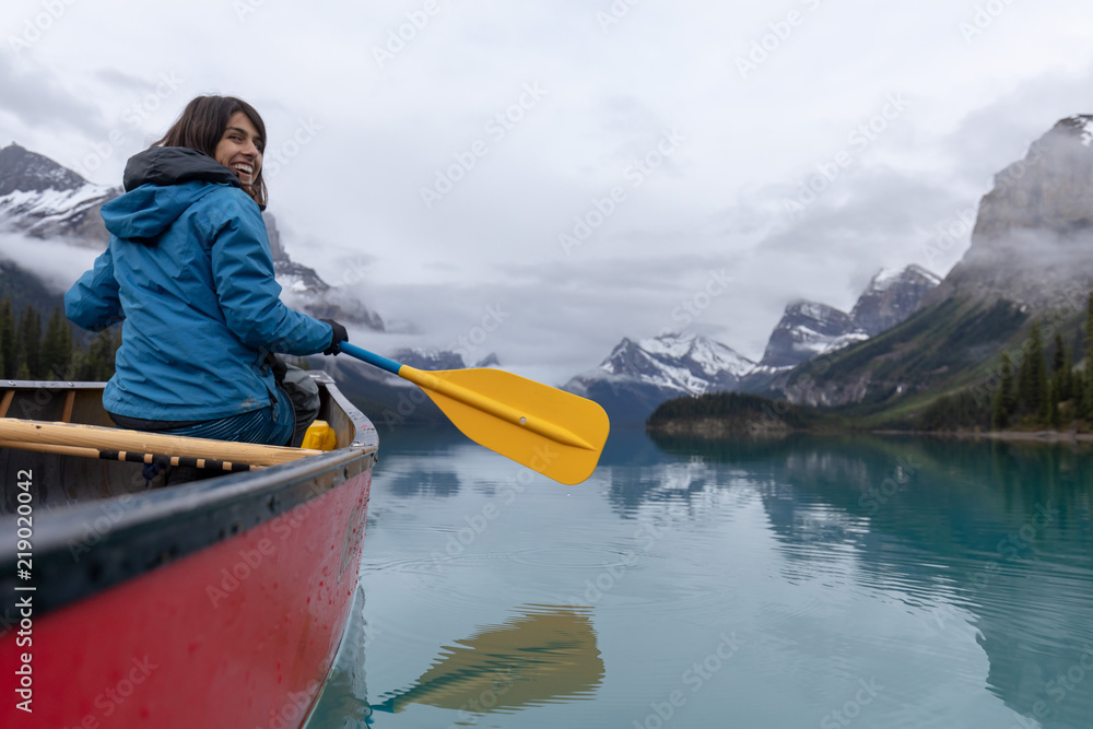 Obraz na plátně Woman in Canoe on Lake in Canadian Rockies
