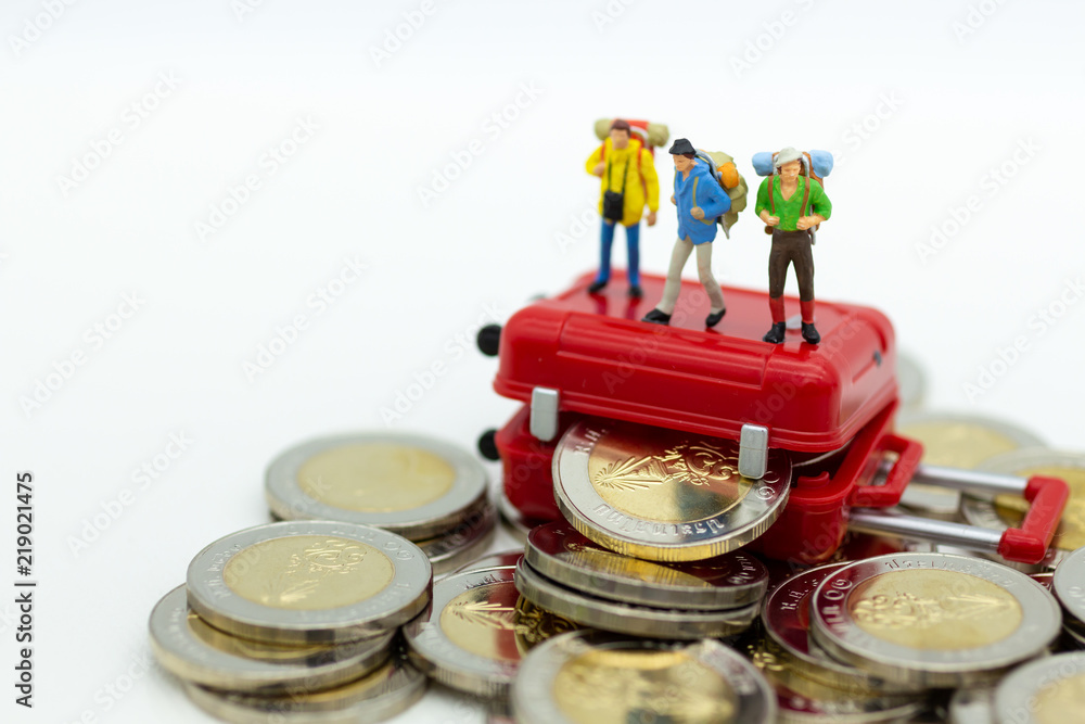 Miniature people : Backpacker group walking on coins. Image use for travel, business concept. Miniature people : Backpacker group walking on coins. Image use for travel, business concept.