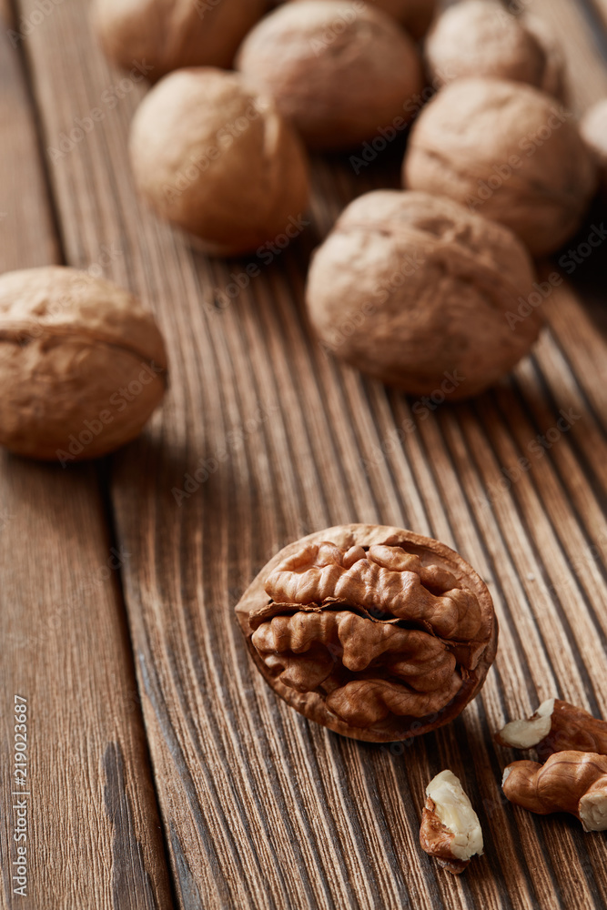 Walnuts and kernels on a dark rusty wood backdrop Walnuts and kernels on a dark rusty wood backdrop