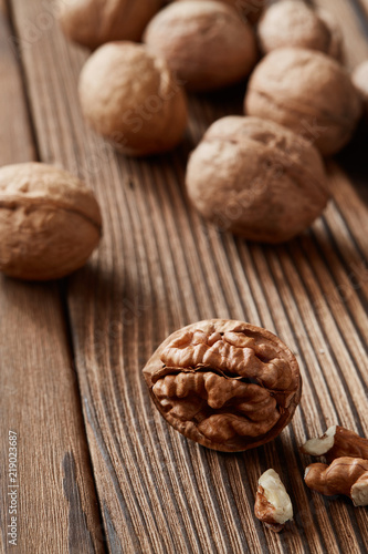 Walnuts and kernels on a dark rusty wood backdrop