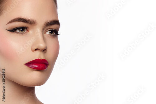Beauty and fashion of the woman with chubby red lips and shooters of a pencil in the eyes. Magnificent eyelashes, eyebrow mascara and red lipstick. Beautiful long neck, pure leather