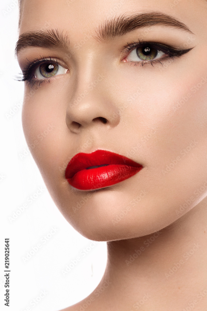 Close up portrait of beautiful young model with professional makeup, perfect skin. Trendy eyelines and red lips. Shiny eyelines Close up portrait of beautiful young model with professional makeup, perfect skin. Trendy eyelines and red lips. Shiny eyelines