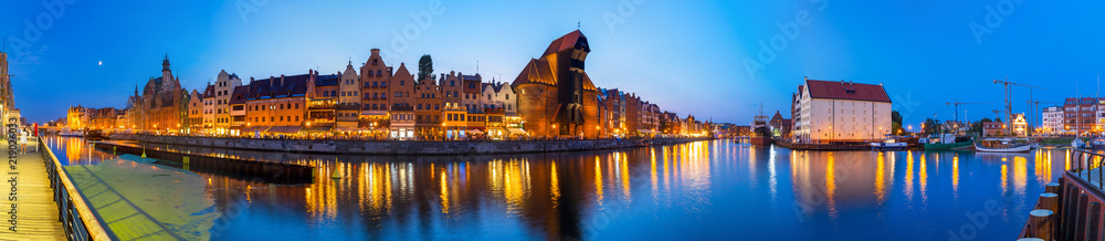 Panorama of Gdansk old town reflected in Motlawa river at dusk, Poland