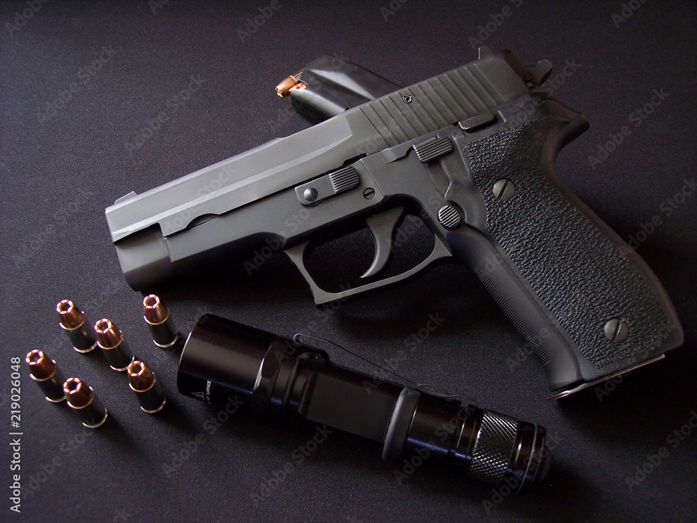 Black 9mm semiautomatic pistol handgun with magazine clip, hollow point