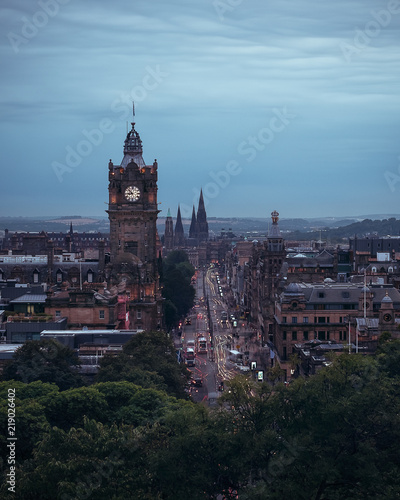 Twilight of city, view of the clock tower and street with old buildings in the evening, Princes Street, Edinburgh, Scotland, United Kingdom