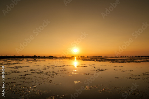 sunset in the Danube delta Romania.Beautiful blueish lights in water.Beautiful sunset landscape from the Danube Delta Biosphere Reserve in Romania