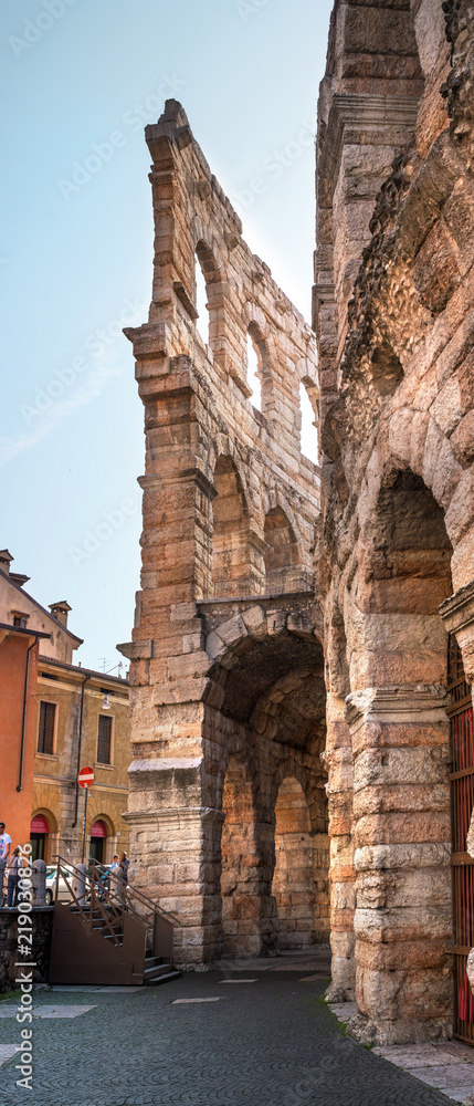 Side view of arches and details of famous ancient roman amphitheatre Arena di Verona, Italy, Europe. The amphitheater is on the square Bra