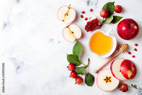 Apple, pomegranate and honey, traditional food of jewish New Year - Rosh Hashana. Copy space background