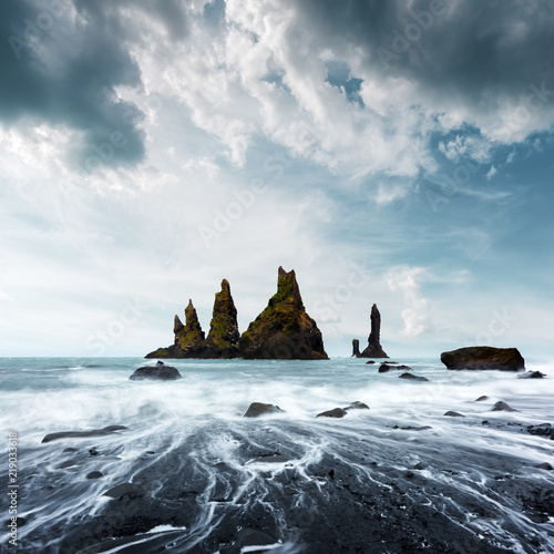 Basalt rock formations Troll toes on black beach. Reynisdrangar, Vik, Iceland photo