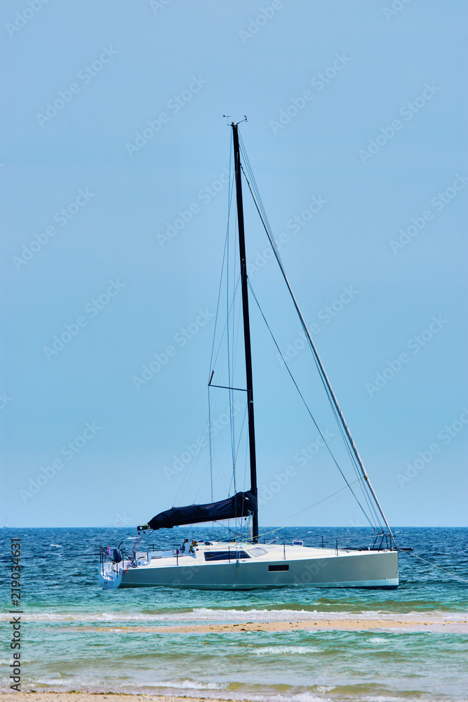 Naklejka premium sailing boat lying in front of Benodet coast, a small town in Brittany, France