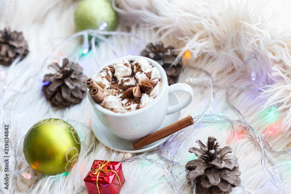 A cup of hot chocolate and marshmallows on the fur. New Year and Christmas concept.