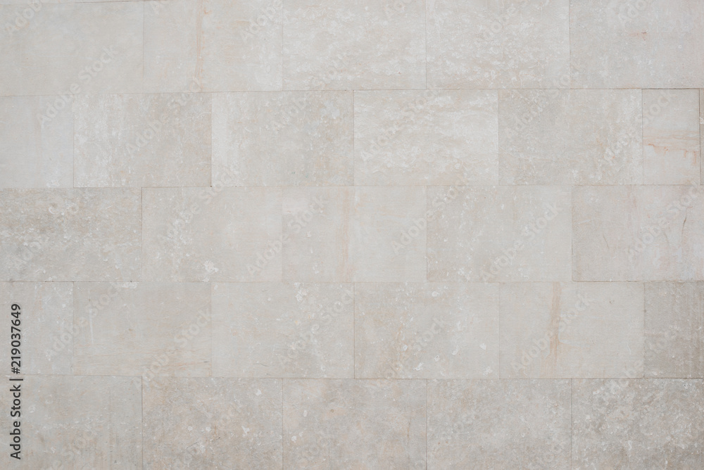 Naklejka premium Old grey marble brick wall in Spain. Texture of marbles bricks