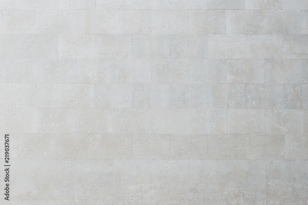 Old gray marble brick wall in Spain. Texture of marbles bricks