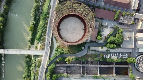 Aerial view of an old district of Rome at sunset, with Tiber River, bridges and the the post-indistrial abandoned Gasometer from above