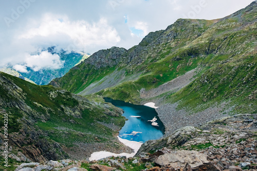 Cold small blue alpine Lake of Waning Moon in summer, aerial view