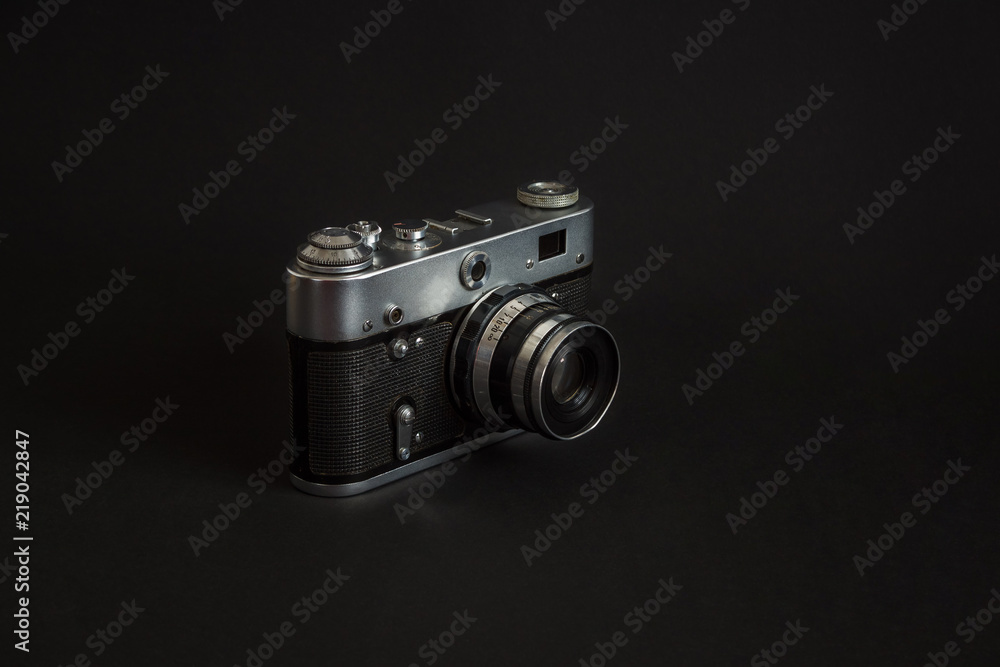 Old analog camera on a black background.