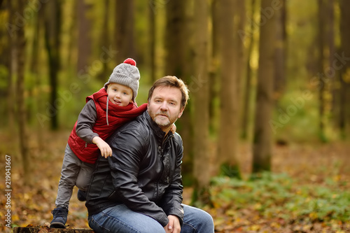 Little boy with his father during stroll in the forest © Maria Sbytova