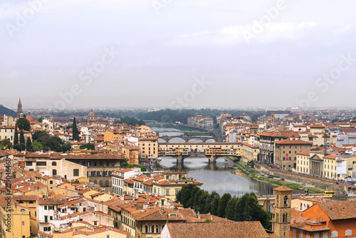Top panoramic cityscape view of old town Florence city, Tuscany region, riverside of Arno river and Ponte vecchio bridge during raining and cloudy from Piazzale Michelangelo in Florence, Italy