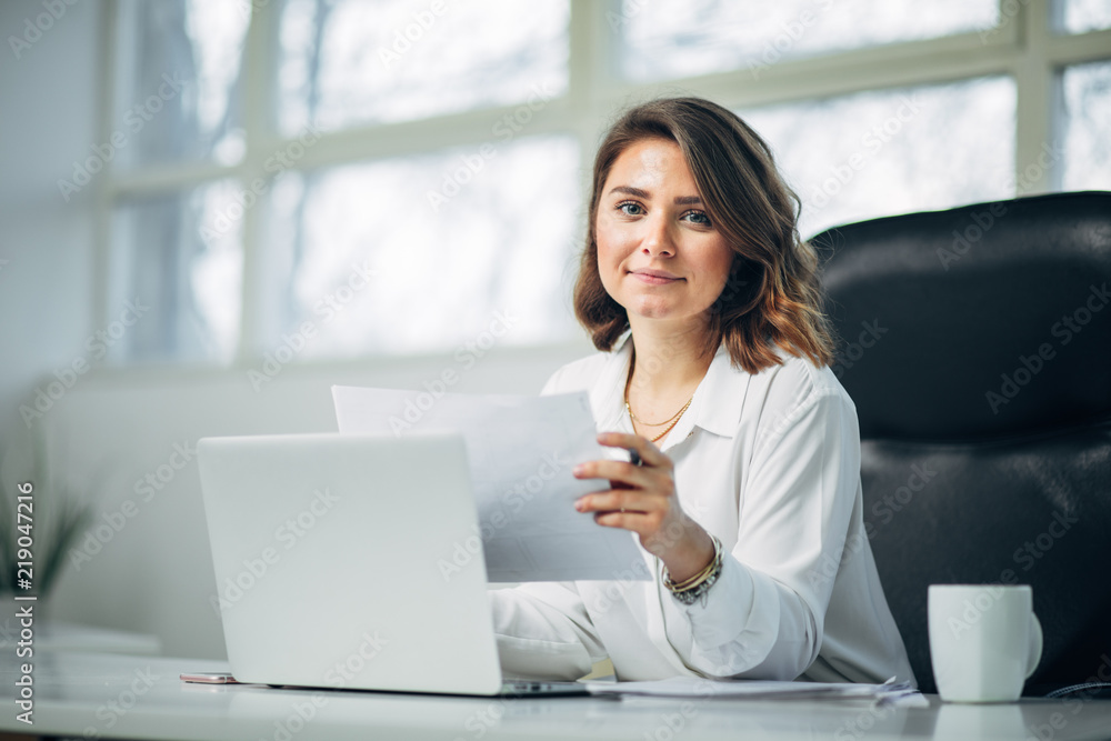 Young woman in office working Young woman in office working