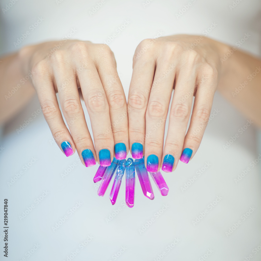 Beautiful woman hands with perfect violet pink and turquoise nail polish  holding little color matching quartz crystals, can be used as background  Photos | Adobe Stock