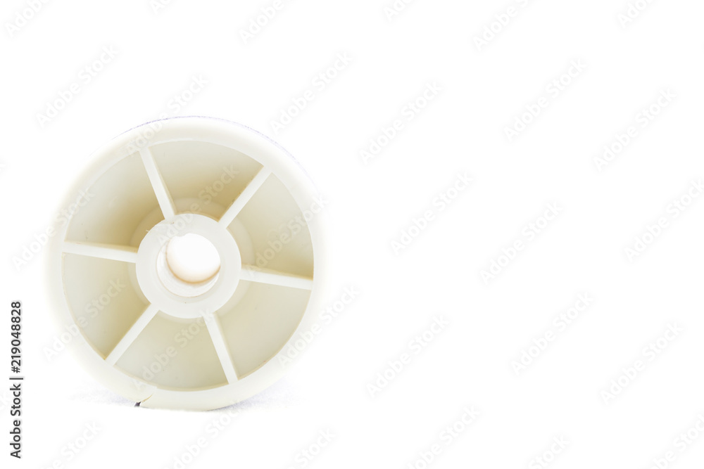 Spool of purple thread and needle on white background Spool of purple thread and needle on white background