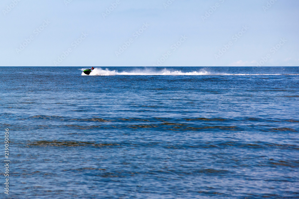 man riding a water motorcycle in the sea