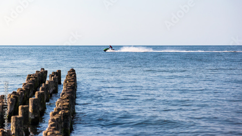 man riding a water motorcycle in the sea © Sergey