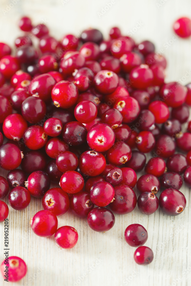 fresh cranberries on white wooden surface fresh cranberries on white wooden surface