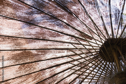 View of close up textile umbrella with bamboo stick as pattern line and background