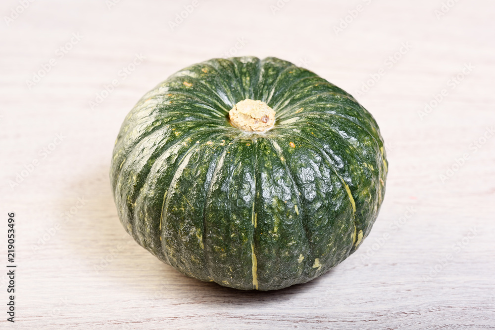 Green pumpkin on the wooden background Green pumpkin on the wooden background