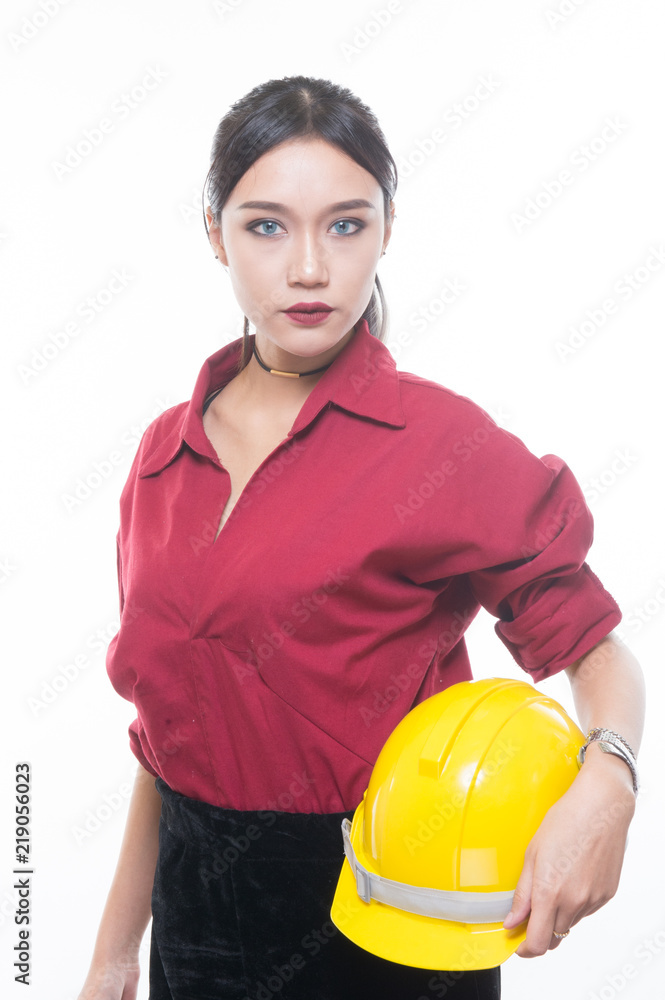 Beautiful engineering woman holding helmet with seriously face in red shirt and yellow helmet with white background, Beautiful engineering woman holding helmet with seriously face in red shirt and yellow helmet with white background,