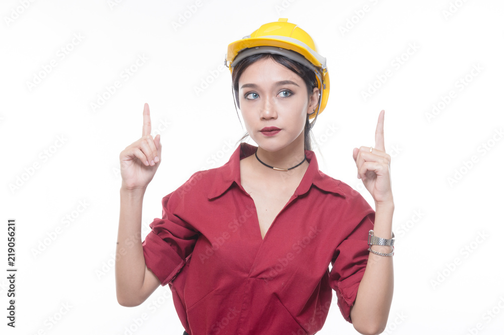 Engineering woman pointing up in red shirt with yellow safety helmet in Studio light Engineering woman pointing up in red shirt with yellow safety helmet in Studio light
