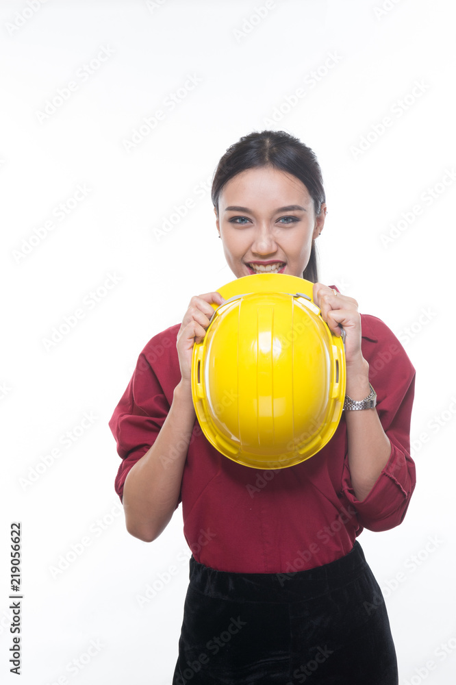 Beautiful engineering woman holding helmet in red shirt and yellow helmet with white background. Beautiful engineering woman holding helmet in red shirt and yellow helmet with white background.