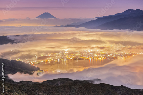 Peak of Mount Fuji And the sea of mist over Lake Suwa in autumn morning