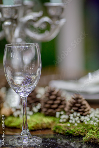 Background view, table setting (wine glass, plate, spoon, fork) placed on the table. Ready to use.