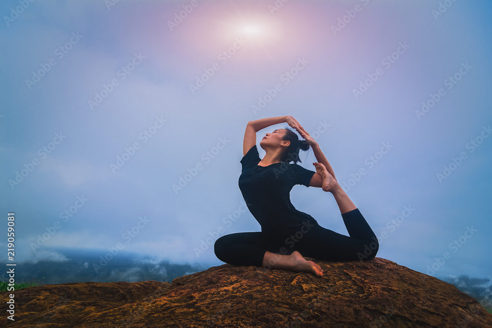 Young girl doing yoga fitness exercise outdoor in beautiful mountains landscape. Morning sunrise Young girl doing yoga fitness exercise outdoor in beautiful mountains landscape. Morning sunrise
