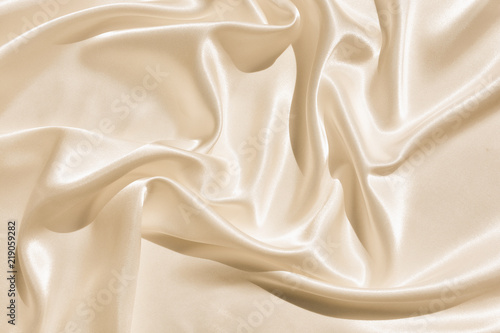 The texture of the satin fabric of beige color for the background  photo