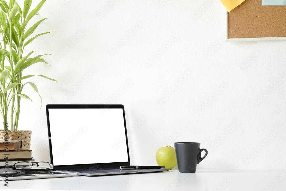 Mockup laptop computer,book and office supplies on white desk. Mockup laptop computer,book and office supplies on white desk.