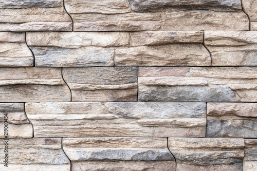 Brown stone tile wall texture and background