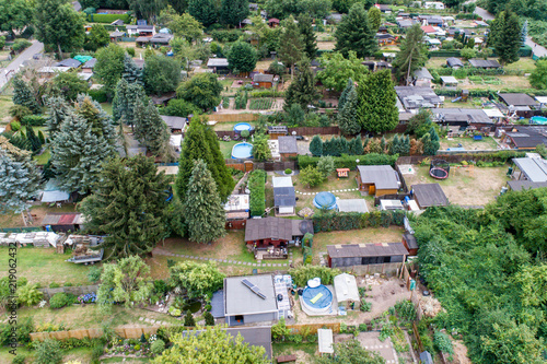 Aerial photo with the drone  a new build-up plot with single houses and gardens  narrow neighbourhood